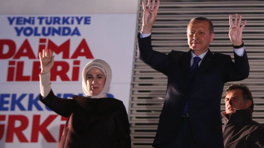 Turkish Prime Minister Recep Tayyip Erdogan (R) and his wife Emine Erdogan (L) greet the crowd from the balcony of the Justice and Development Party headquarters in Ankara, Turkey on March 31, 2014. Turkey's Premier Recep Tayyip Erdogan claimed victory for his Islamic-rooted party in Sunday's key local elections and warned his foes they will 'pay the price' for plotting his downfall. AFP PHOTO / ADEM ALTAN (Photo credit should read ADEM ALTAN/AFP/Getty Images)