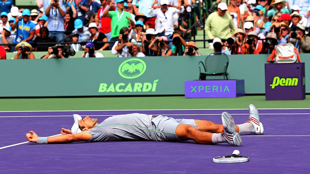 Novak Djokovic collapses in exhausted joy after winning the Miami Masters final against Rafael Nadal. 