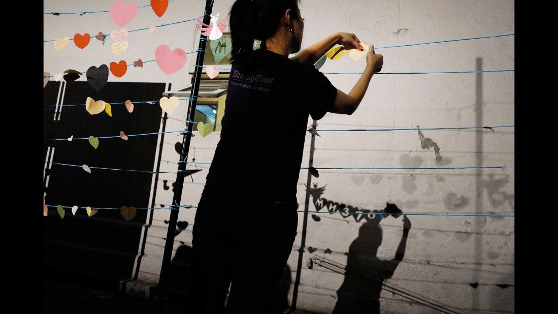 On March 30, 2014, a woman in Kuala Lumpur prepares for an event in honor of those aboard Flight 370.