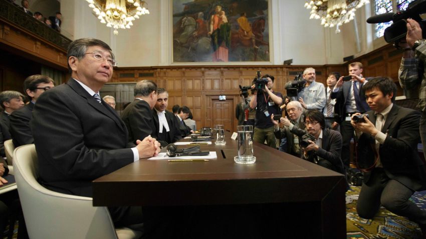 Japanese Ambassador to the Netherlands Koji Tsuruoka, left, waits for the International Court of Justice to deliver its verdict in The Hague, Netherlands, Monday March 31, 2014.