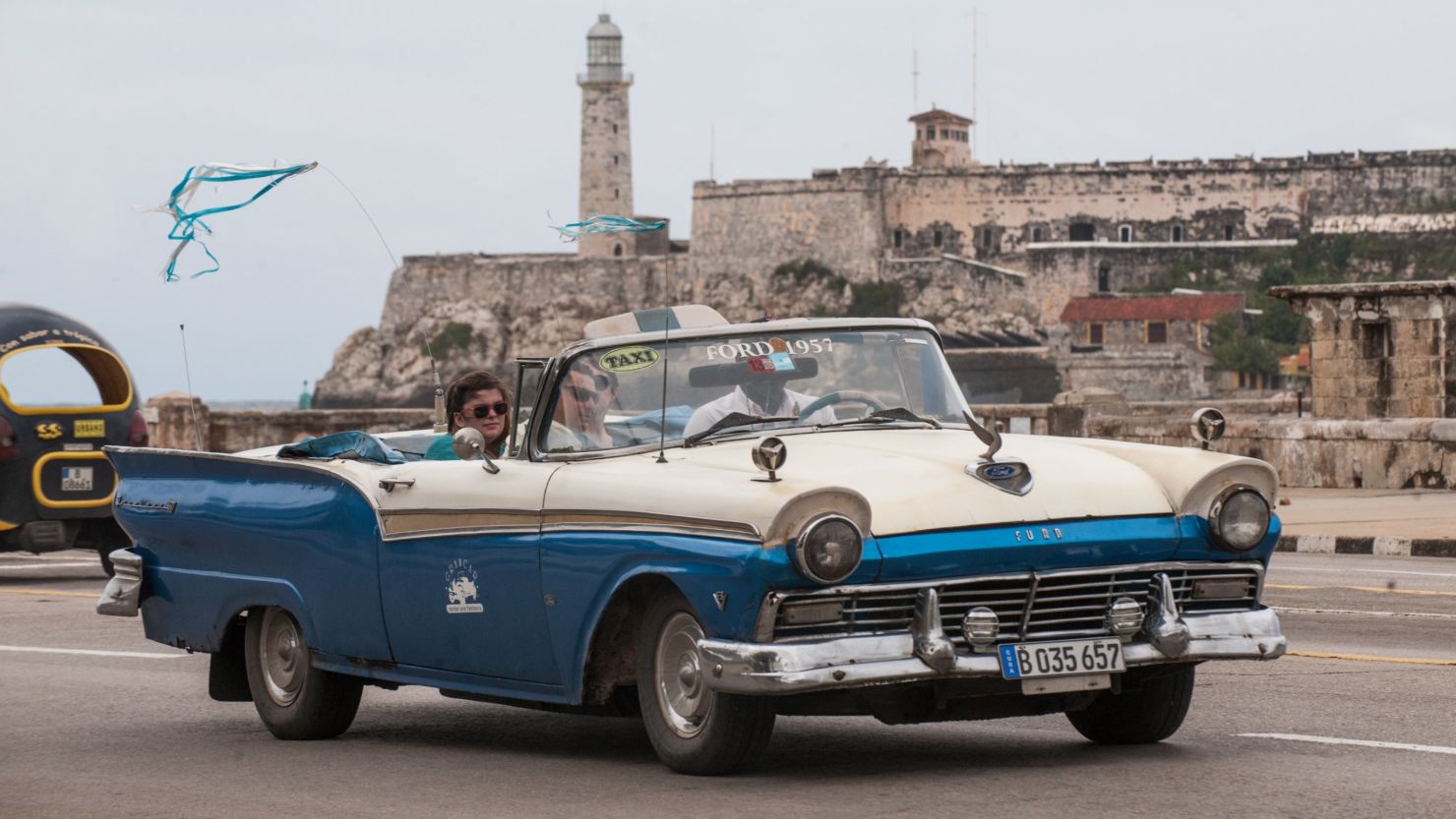 Tourists travel in a taxi, on January 8, 2014 in Havana. Cuban lawmakers approved an international investment measure.