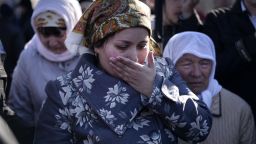 The wife of Reshat Ametov wipes her tears during his funeral in Simferopol on March 18, 2014.