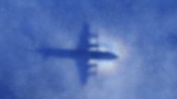 This shadow of a Royal New Zealand Air Force P3 Orion aircraft is seen on low cloud cover while it searches for missing Malaysia Airlines flight MH370, over the Indian Ocean on March 31, 2014. No time limit will be imposed on the search for MH370 because the world deserves to know what happened, Australian Prime MinisterTony Abbott said, as a ship equipped to locate the plane's 'black box' prepared to set sail. AFP PHOTO / POOL / Rob GRIFFITH (Photo credit should read ROB GRIFFITH/AFP/Getty Images)