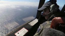 Royal New Zealand Air Force P-3 Orion's captain, Wing Comdr. Rob Shearer watches out of the window of his aircraft while searching for the missing Malaysia Airlines Flight MH370 in the southern Indian Ocean, Monday, March 31, 2014. (AP Photo/Rob Griffith/Pool/AP)