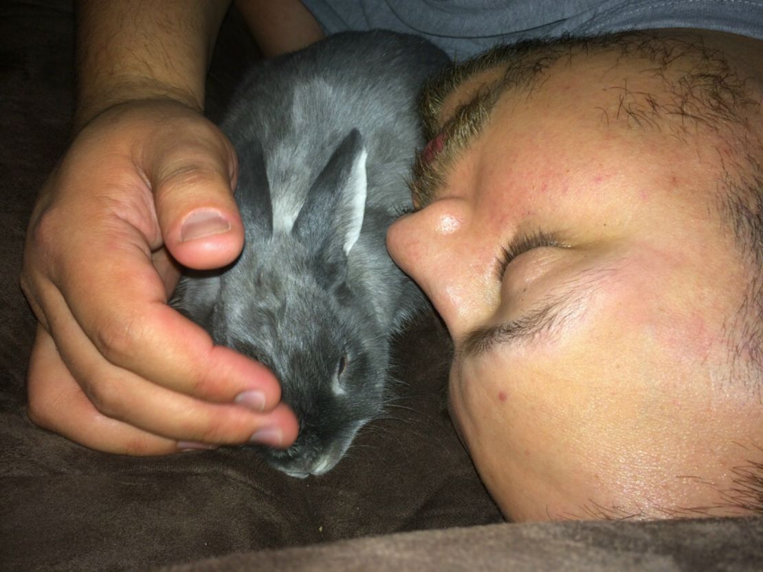 Mitchell Casado snuggles with his rescue rabbit, Buddy.