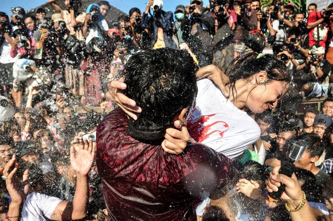 APRIL 1 - BALI, INDONESIA : A young Balinese man tries to kiss a woman during the Kissing Festival known as "Omed-Omedan" at Sesetan village in Denpasar. The kissing festival is held annually, one day after Balinese Hindus celebrate the Nyepi Day of Silence. During the festival, Balinese youths gather first to pray, then to kiss and dance as spectators douse the teenagers with water. The festival is intended to fend off bad luck in the year ahead.