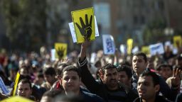 Supporters of the Muslim Brotherhood chant slogans and raise four fingers, the symbol known as 'Rabaa', which means four in Arabic, remembering those killed in the crackdown on the Rabaa al-Adawiya protest camp in Cairo last year, during a demonstration in Cairo on January 24, 2014.