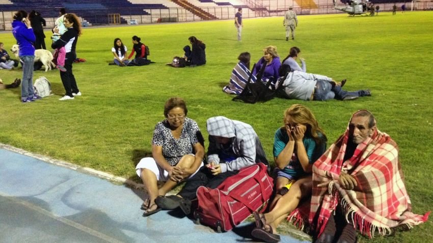 People take refuge at a stadium in Iquique, Chile, after an 8.0-magnitude earthquake struck off the coast of the Latin American country on Tuesday, generating a tsunami.