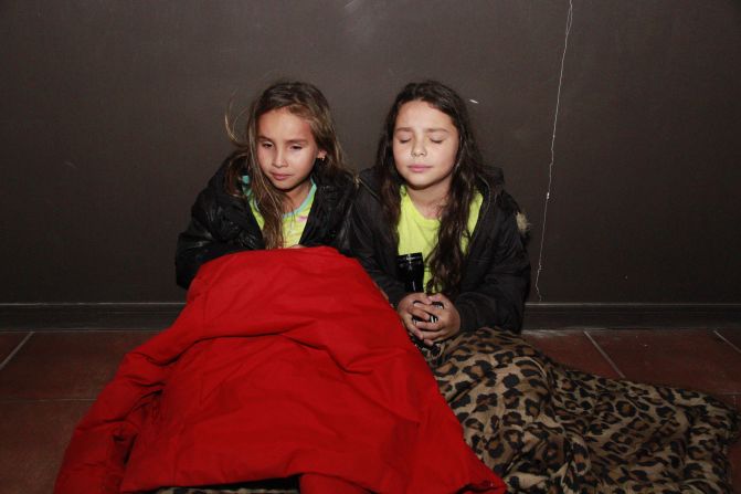 Girls wait in a hallway before evacuating Iquique on April 1.