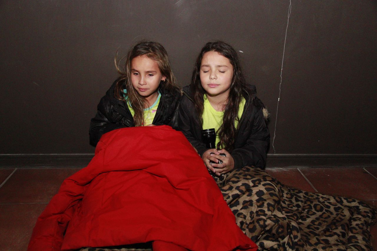 Girls wait in a hallway before evacuating Iquique on April 1.