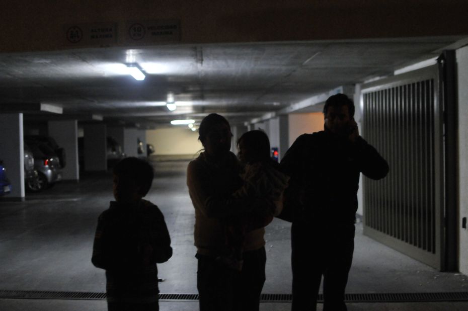 Iquique residents wait in a parking garage after the earthquake.