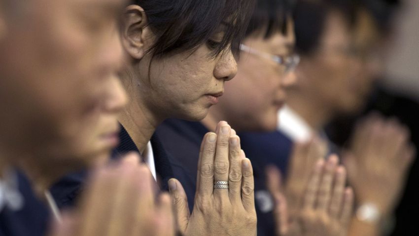 Volunteers from Taiwan's Buddhist association offer prayers for the Chinese passengers aboard the missing Malaysia Airlines flight MH370, at a hotel in Beijing, China Tuesday, April 1, 2014. Although it has been slow, difficult and frustrating so far, the search for the missing Malaysia Airlines jet is nowhere near the point of being scaled back, Australia's Prime Minister Tony Abbott said. The three-week hunt for Flight 370 has turned up no sign of the Boeing 777, which vanished March 8 with 239 people bound for Beijing from Kuala Lumpur. (AP Photo/Andy Wong)