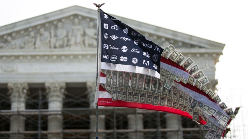 WASHINGTON, DC - OCTOBER 8:  A flag adorned with corporate logos and fake money flies during a rally against money in politics, at the Supreme Court in Washington, on October 8, 2013 in Washington, DC. On Tuesday, the Supreme Court heard oral arguments in McCutcheon v. Federal Election Committee, a first amendment case that will determine how much money an individual can contribute directly to political campaigns. (Photo by Drew Angerer/Getty Images)