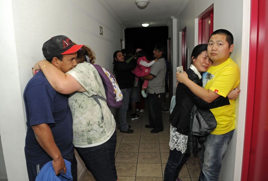 People embrace on the upper floor of an apartment building in Iquique on April 1. 