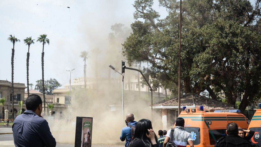 Egyptian look on as a bomb struck a police post near Cairo University in the centre of Egypt's capital on April 2, 2014, which was followed by two further blasts.