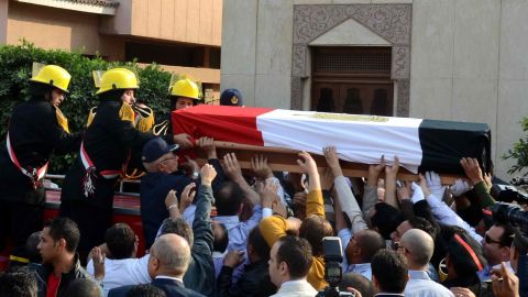 Mourners carry the coffin of Brigadier General Tariq al-Mirgawi during his funeral in the Egyptian capital Cairo, on April 2, 2014.