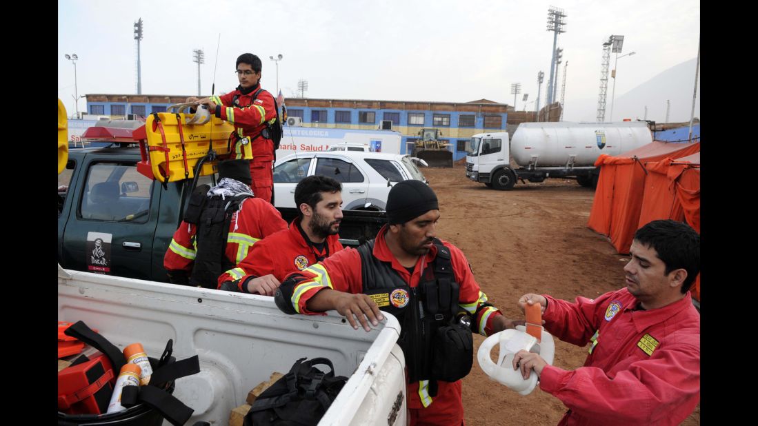 Rescue personnel get ready to go into action April 2 in Iquique.  More than 2,500 homes sustained serious structural damage in the region around the northern port city, an official said.