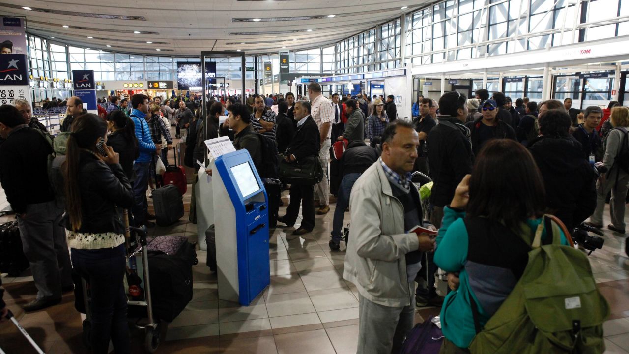 People wait at the Arturo Merino Benitez Airport in Santiago, Chile, on April 2 as flights are canceled because of the earthquake.