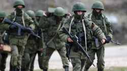 Russian military personnel move towards a Ukrainian military base on March 19, 2014 in Perevalnoe, Ukraine.