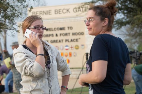 Krystina Cassidy and Dianna Simpson, waiting outside the Bernie Beck Gate at Fort Hood, try to contact their husbands, who are stationed at the post.