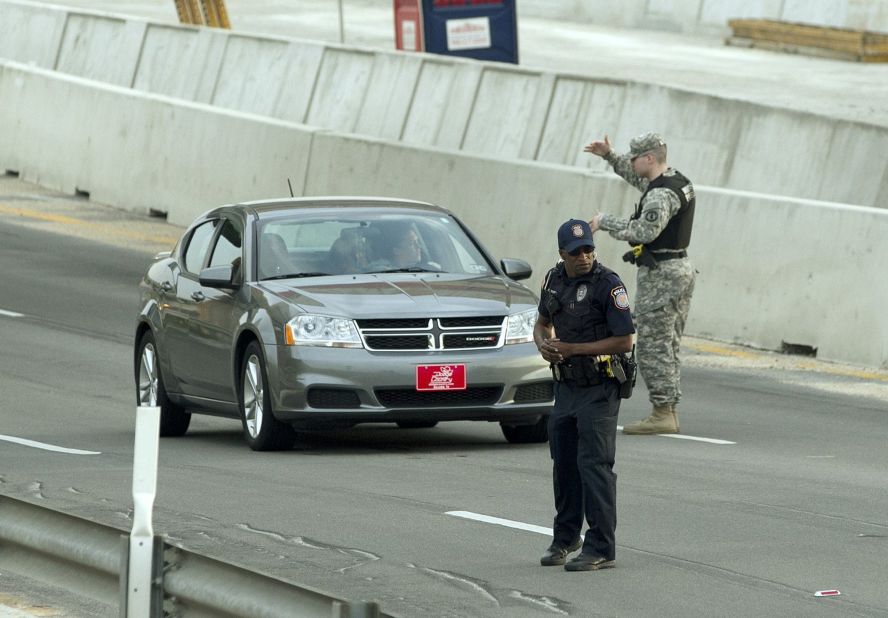 A Bell County Sheriff's Department official stands near a vehicle as cars are checked at the Bernie Beck Gate.