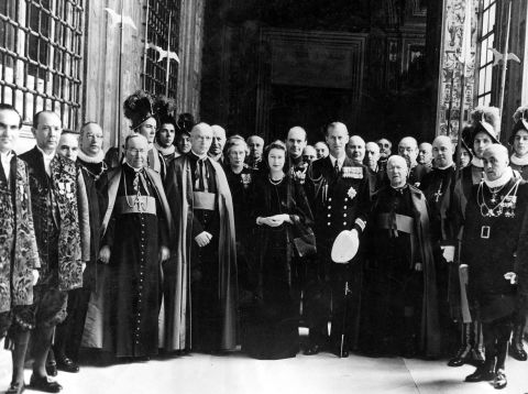 The Queen, then as Princess Elizabeth, poses for a group photo with her entourage, Vatican knights and Swiss Guards following a talk with Pope Pius XII in April 1951.