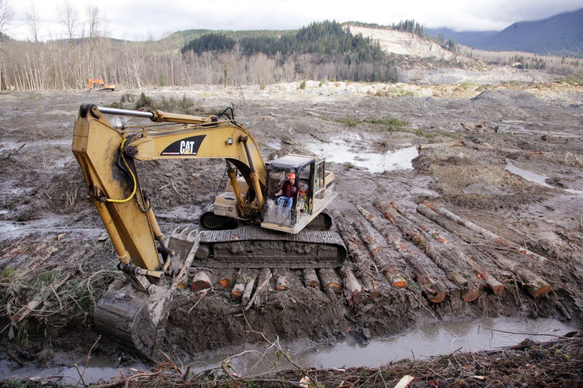 An excavator clears a drainage channel on Wednesday, April 2.