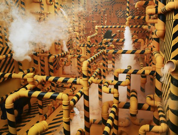 The artist tried to express her difficulties in communication with some people through a maze of pipes. "I used yellow and black, as those colors are often seen on signs which warn of danger," she says. The black dog in the corner of the picture represents a person who was troubling Lee at the time. 