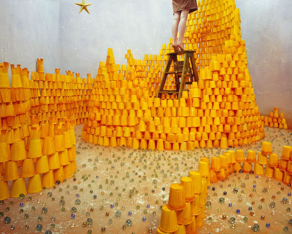 <em>Reaching for the star</em><br /><br />In this image, over 2,000 hand-painted paper cups are stacked together as bricks of a fragile castle, which represents the human need for betterment. Lee explains: "I wanted to express the process of heading toward your desire, along with the effort it takes to achieve your dream, which is represented by the star." The glass marbles spread on the floor have several meanings: fallen stars, grains of sand, and the danger of the paper-cup castle collapsing. 
