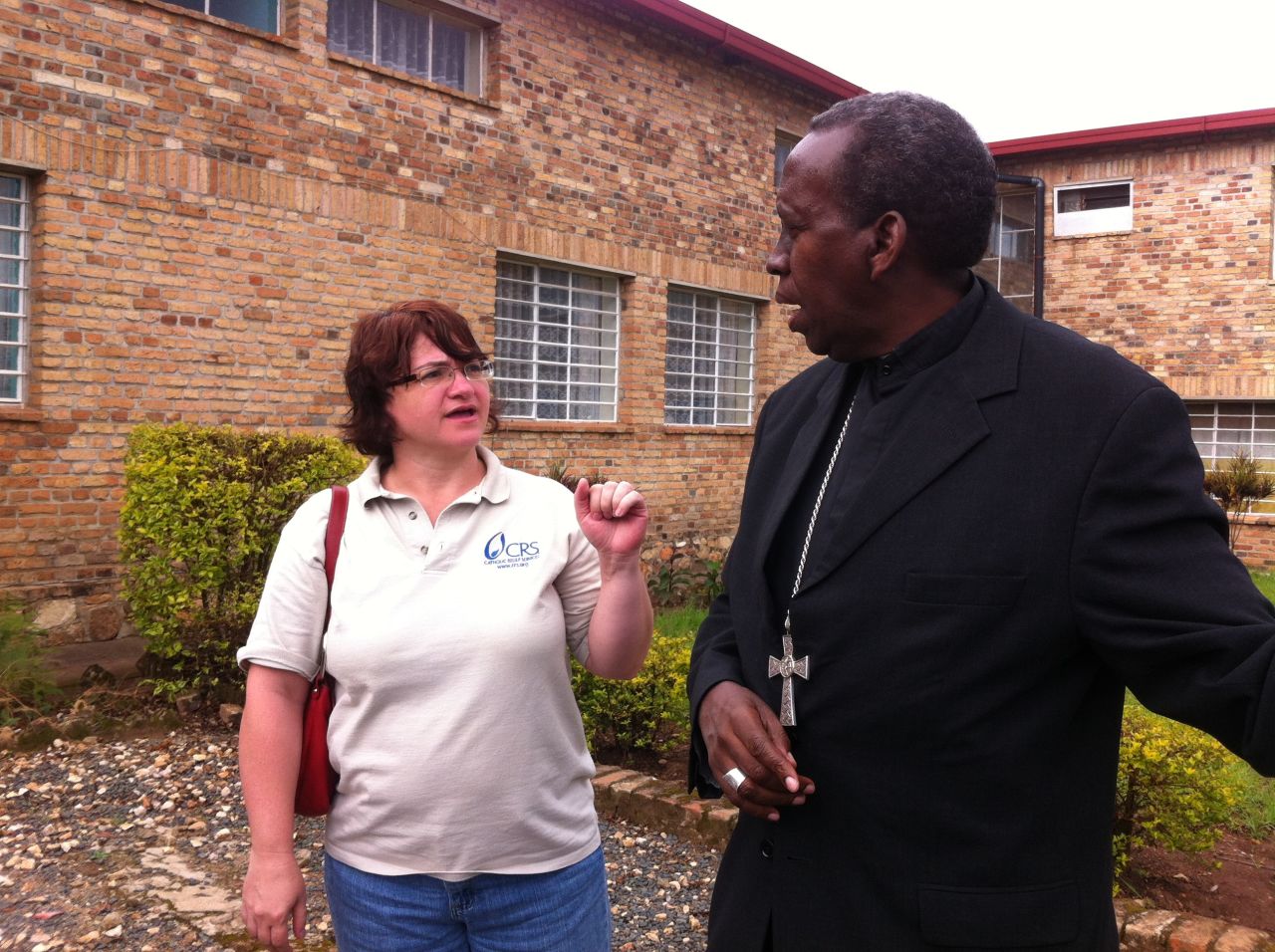 Leann Hager, Catholic Relief Services country representative in Rwanda until 2014, speaks with a local bishop about working together to reconcile communities after the genocide.