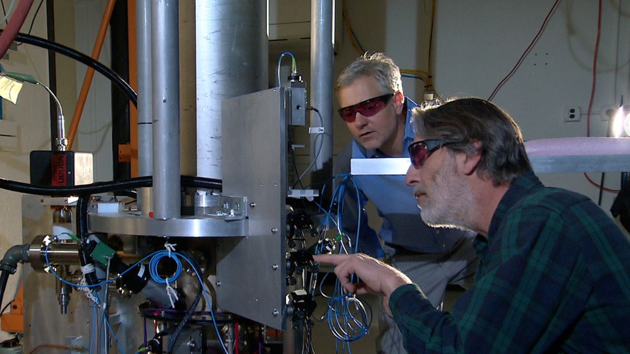 Physicists Steve Jefferts, front, and Tom Heavner work on the NIST-F2 atomic clock, a new time standard in the United States. 