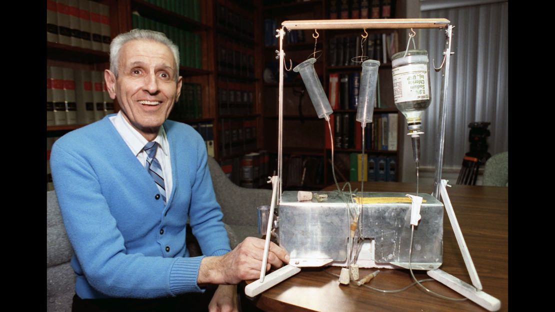 Jack Kevorkian poses with his Thanatron suicide machine" in February 1991.
