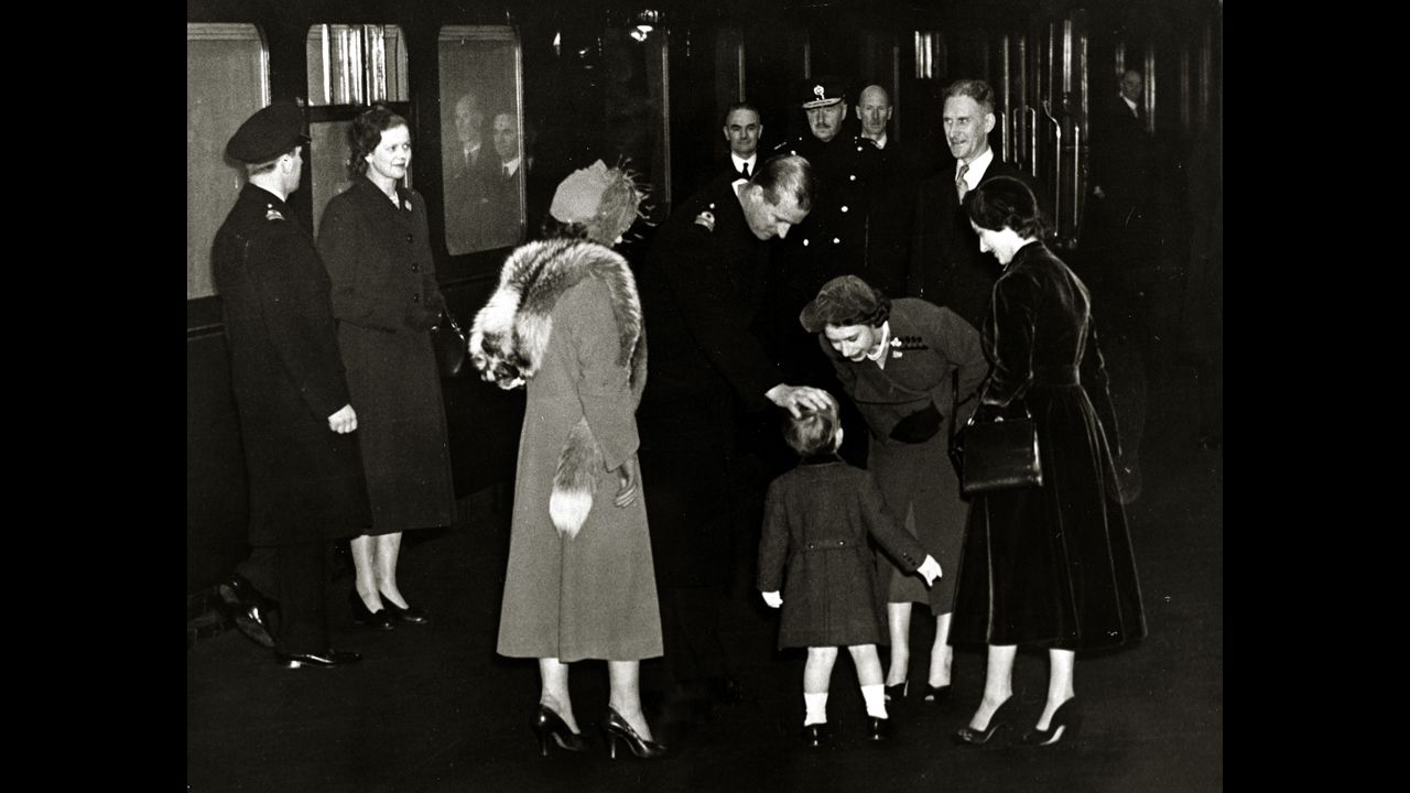 The future Queen Elizabeth II and her husband, the Duke of Edinburgh, greet their son Charles at Euston Station in London after returning from Canada in November 1951. 