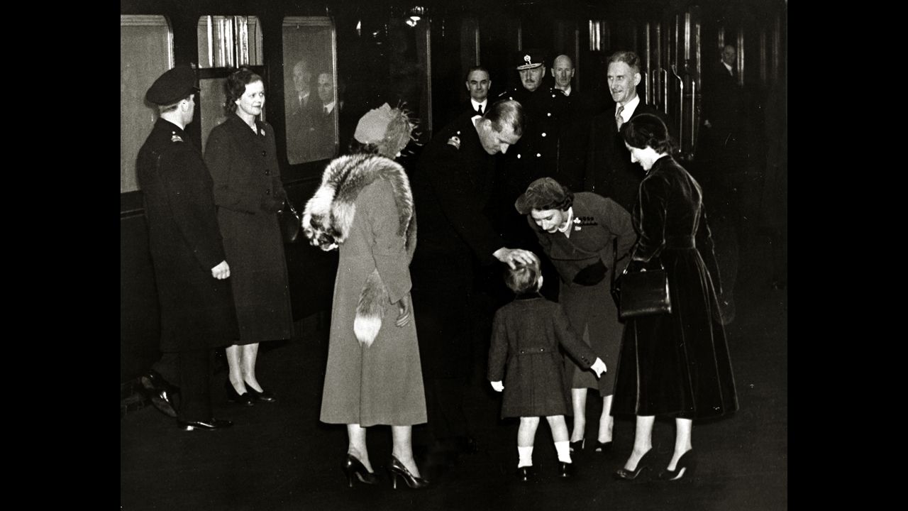 The future Queen Elizabeth II and her husband, the Duke of Edinburgh, greet their son Charles at Euston Station in London after returning from Canada in November 1951.