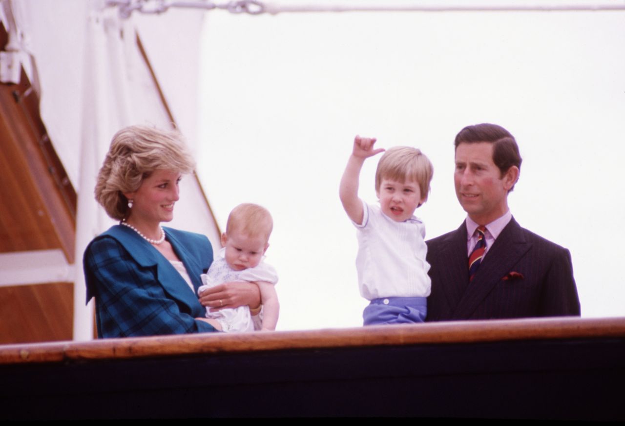 Princess Diana and Prince Charles hold Harry, left, and William on the deck of the Royal Yacht Britannia during a tour of Italy in May 1985.