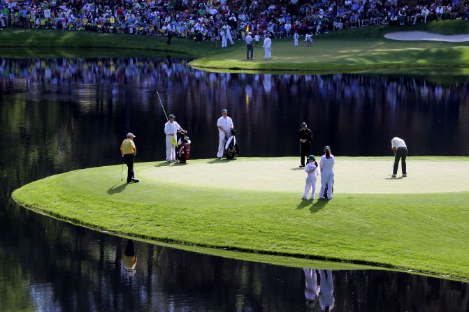 Palmer putts as fellow greats Jack Nicklaus (left) and Gary Player (center) look on during the Par 3 Contest prior to the 2011 Masters at the course the American called "a pleasure to play on."