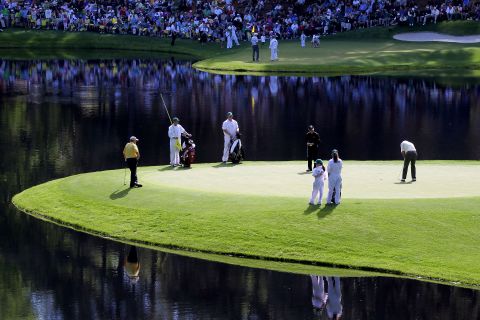 Palmer putts as fellow greats Jack Nicklaus (left) and Gary Player (center) look on during the Par 3 Contest prior to the 2011 Masters at the course the American called "a pleasure to play on." 