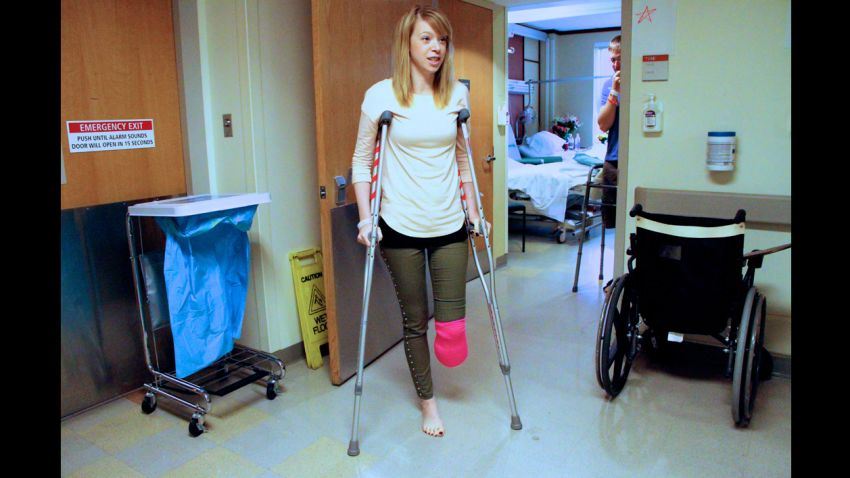 Adrianne Haslet-Davis walks using crutches outside her hospital room a week after the attacks.