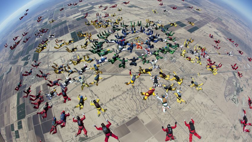 In this  Tuesday, April 1, 2014 photo provided by The World Team, a group of 222 skydivers from 28 nations, team members dive over Eloy, Ariz. The jump was part of the group's ongoing attempt to set a world record by forming two distinct aerial formations within the same dive. The team did not break the record with this attempt. (AP Photo/World Team, Andrey Veselov)