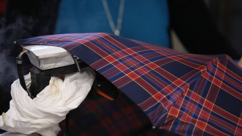 The umbrellas are decorated in an "English style," either in plain colors or patterned with pinstripes, tartan or regimental stripes.