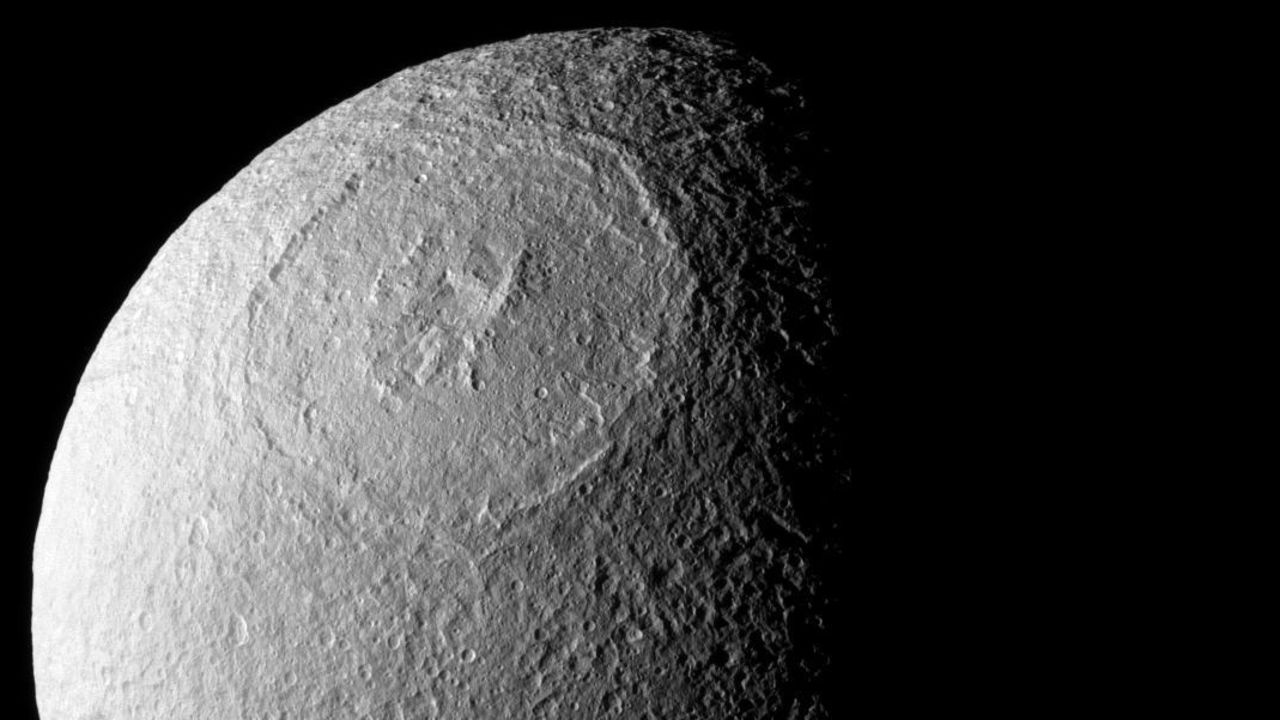The Odysseus Crater spans 280 miles across the northern hemisphere of Tethys.