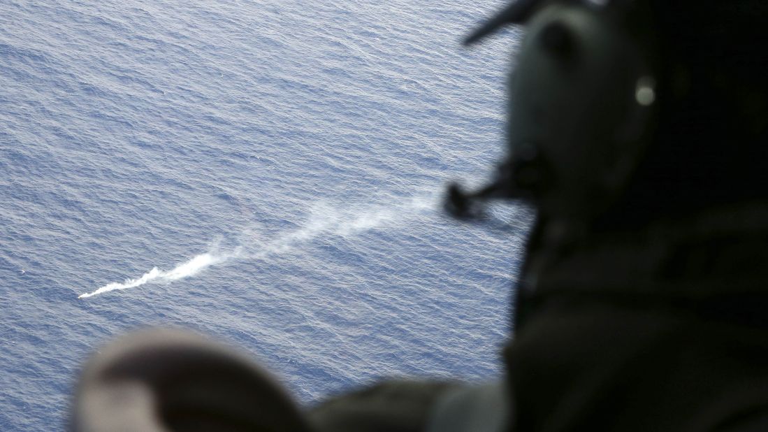 A member of the Royal New Zealand Air Force looks at a flare in the Indian Ocean during search operations on April 4, 2014.