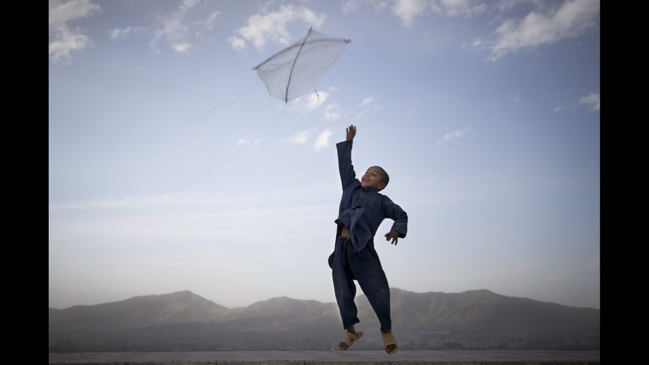 An Afghan boy flies his kite in May on a hill overlooking Kabul.