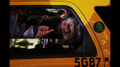 A woman reacts in a New York taxi as television networks call the 2008 presidential race for Barack Obama.