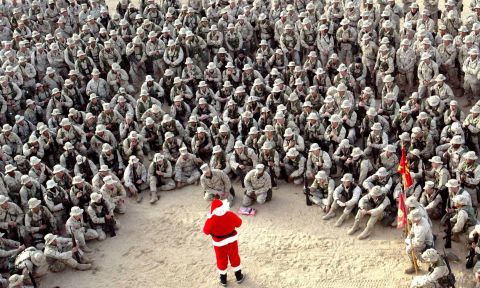 Hundreds of U.S. Marines gather at Camp Commando in the Kuwaiti desert during a Christmas Eve visit by Santa Claus in 2002.