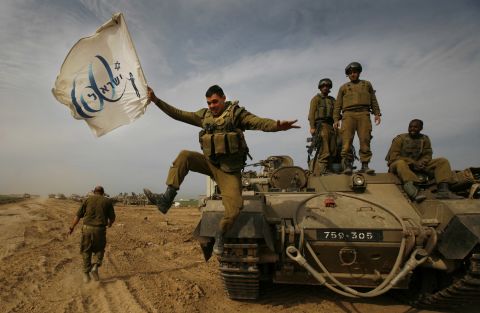 She was the only woman on a team of 11 Associated Press photographers that won the 2005 Pulitzer Prize for for their coverage of the Iraq War. In this photo from 2009, Niedringhaus captures an Israeli soldier jumping off an armored vehicle, while carrying a flag of the country's 60th anniversary.
