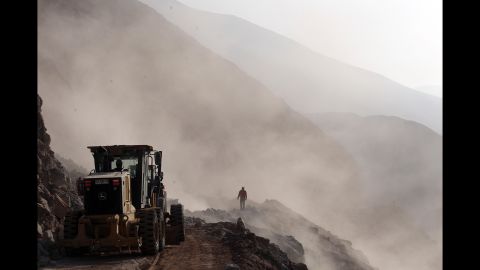 Heavy machinery is used to clear debris on the road leading to the town of Camarones, Chile, on Thursday, April 3. Access to the town was cut off when an 8.2-magnitude earthquake struck northern Chile on April 1.