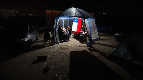 People take shelter under a tent after they left their homes in Alto Hospicio, Chile, on April 3.