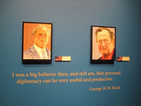A self-portrait of former President George W. Bush, left, and a portrait Bush painted of his father, former President George H.W. Bush, is on display Friday, April 4, at the George W. Bush Presidential Library and Museum in Dallas.