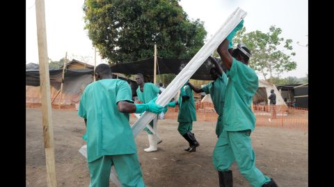 Health specialists work March 31, 2014, at an isolation ward for patients at the facility in southern Guinea.